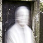 Тайны и загадки - Ghostly figure emerging from tombsto